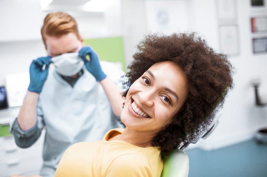smiling woman laying back in a dental chair